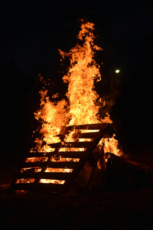 a bonfire is lit up in the dark, slide show, vandalism, square, file photo