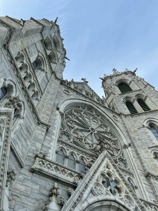 a very tall building with a clock on it's side, by Jacob Burck, pexels contest winner, romanesque, quebec, gothic cathedral, front and side views, view from bottom to top