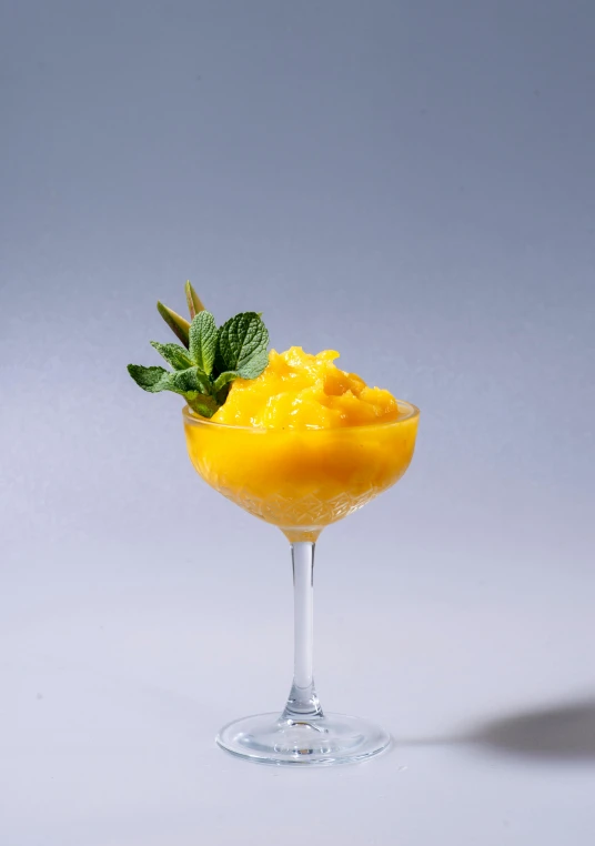 a glass of mango sorbet with a sprig of mint, inspired by Carlo Martini, unsplash, renaissance, high quality”, full body image, grain”, bright ”