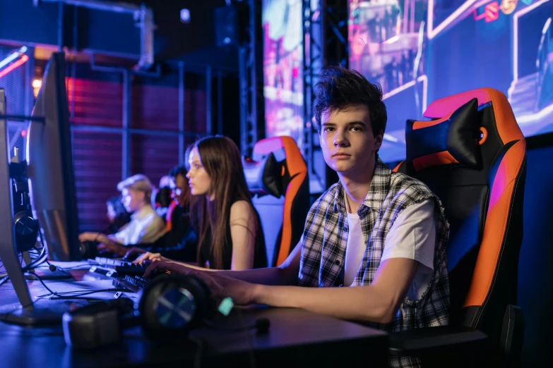 a group of people playing a game on a computer, a portrait, by Adam Marczyński, shutterstock, realism, model is wearing techtical vest, gaming chair, high school, people enjoying the show
