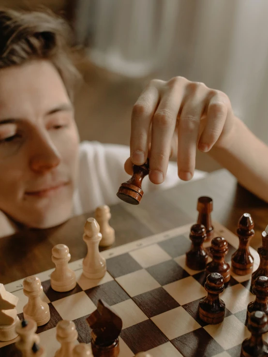 there is a woman that is playing a game of chess