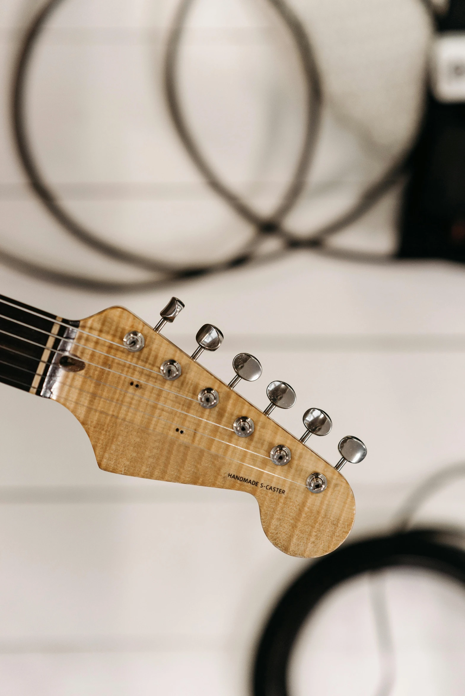 a close up of a person holding a guitar, electric guitars, on display, side of head