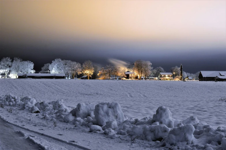 a road in the middle of a snow covered field, pexels contest winner, land art, nightime village background, white sky, swedish houses