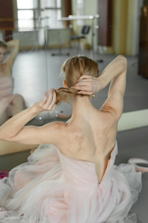 a woman in a pink dress sitting in front of a mirror, by Elizabeth Polunin, shutterstock, showing her shoulder from back, scratching head, 15081959 21121991 01012000 4k, ponytail