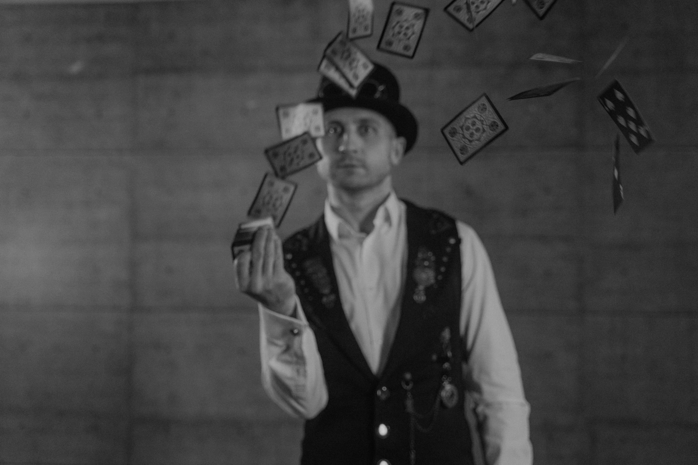 a black and white photo of a man holding playing cards, inspired by Arlington Nelson Lindenmuth, magic and steam - punk inspired, video still, jesse pinkman, [ floating ]!!