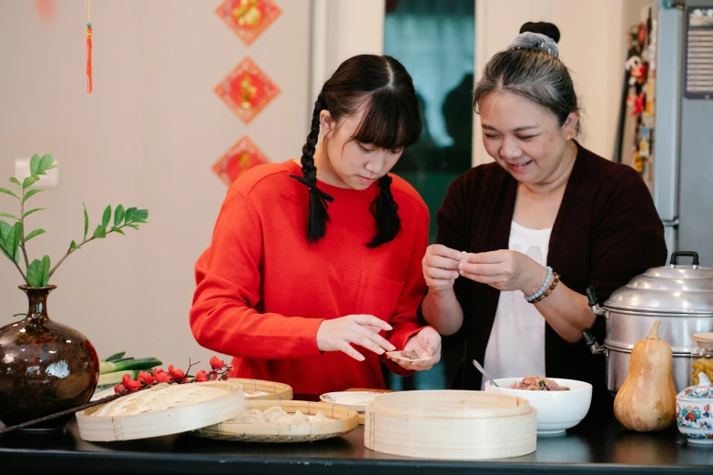 a couple of women standing next to each other in a kitchen, inspired by Tan Ting-pho, pexels contest winner, serving suggestion, community celebration, profile image, chinese style