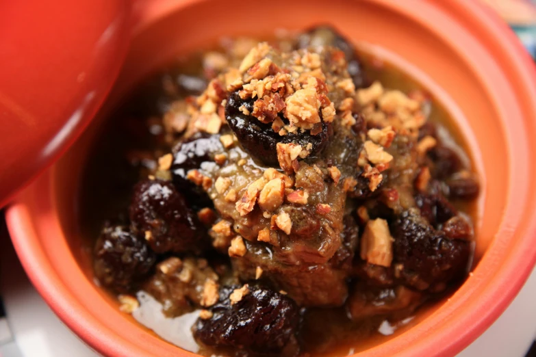 a close up of a bowl of food on a table, hurufiyya, traditional corsican, garnet, sludgy, goat