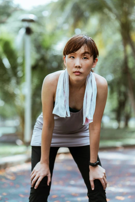 a woman standing on a skateboard in a park, by Natasha Tan, pexels contest winner, happening, wearing a towel, sad look, wearing : tanktop, asian woman