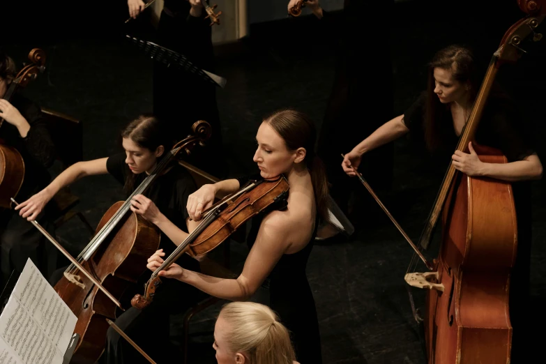 a group of women playing musical instruments on a stage, by Elizabeth Durack, unsplash, baroque, conductor, rectangle, ignant, teaser