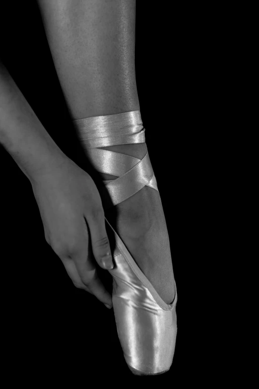 a black and white photo of a ballet shoe, an album cover, arabesque, white bandage tape on fists, skin reflective metallic, ffffound, knee