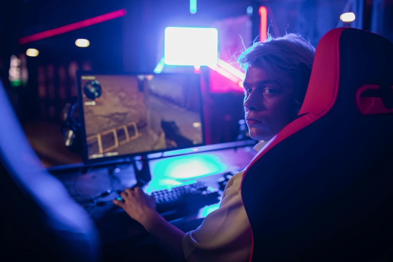 a woman sitting in front of a computer monitor, pexels, realism, first person shooter game hud, tournament, red and blue neon, instagram post