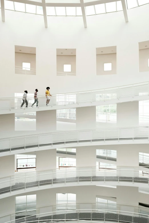 a group of people walking inside of a building, by Fei Danxu, unsplash contest winner, light and space, white background, terraces, children's, museum photograph