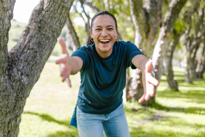 a woman throwing a frisbee in a park, pexels contest winner, happening, greta thunberg smiling, alexandria ocasio cortez, portrait image, flying trees and park items