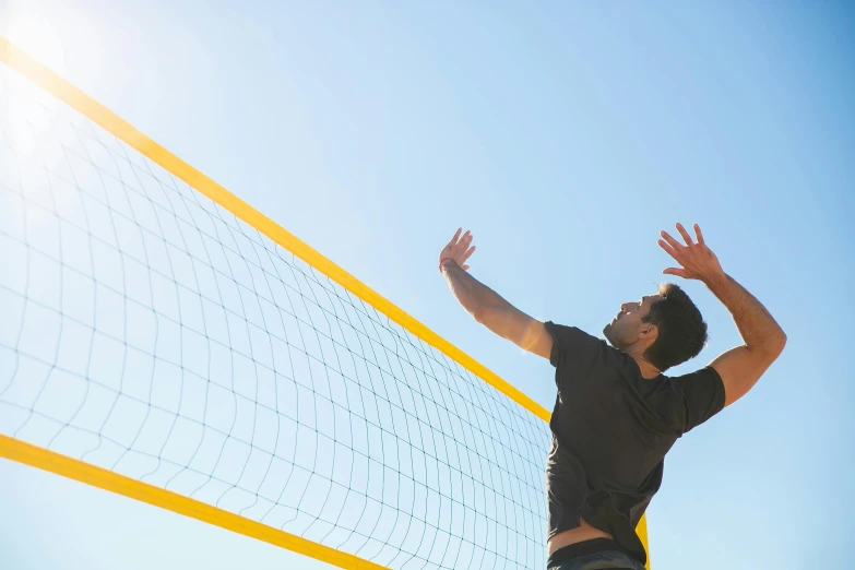 a man reaching up to hit a volleyball ball, shutterstock, figuration libre, on a sunny day, manly, netting, lachlan bailey