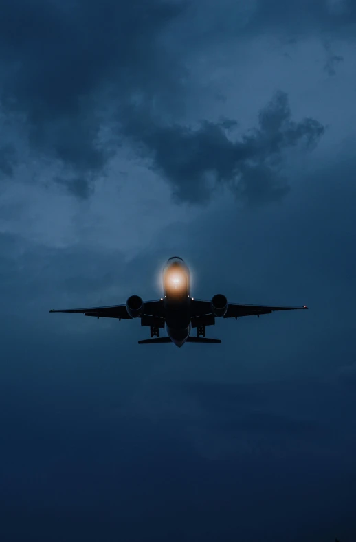 a large jetliner flying through a cloudy sky, by Robert Jacobsen, shutterstock, gloomy lights in the sky, front lit, profile image, instagram picture
