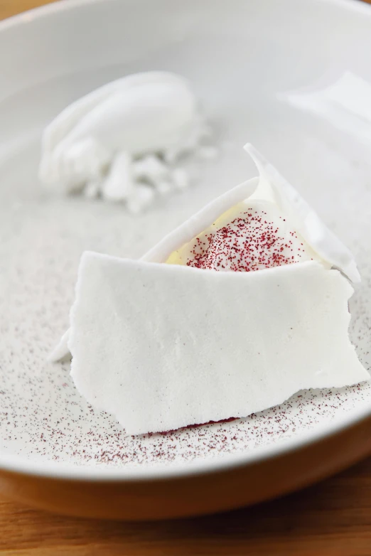 a close up of a plate of food on a table, a stipple, marshmallow, silver white red details, made of lab tissue, cream