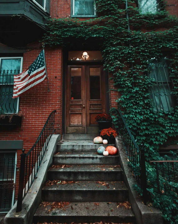 a building with a bunch of pumpkins on the steps, inspired by Elsa Bleda, pexels contest winner, american romanticism, us flag, old apartment, 🚿🗝📝, red and green color scheme