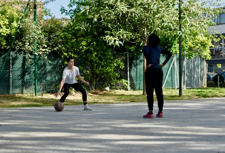 a couple of people playing a game of basketball, 15081959 21121991 01012000 4k, reportage photo, environmental shot, small