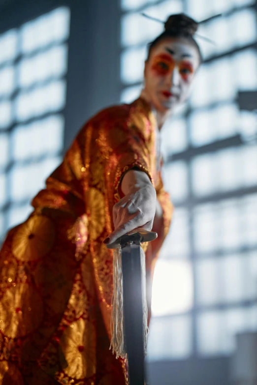 a woman dressed as a geisha holding a sword, a statue, inspired by Kanō Hōgai, hyperrealism, 7 0 mm. dramatic lighting, film still of the joker, realistic glass sculpture, detail