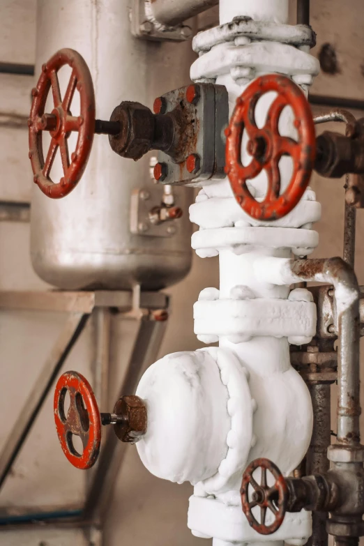 a close up of pipes and valves in a building, white steam on the side, a photograph of a rusty, white machinery, still image