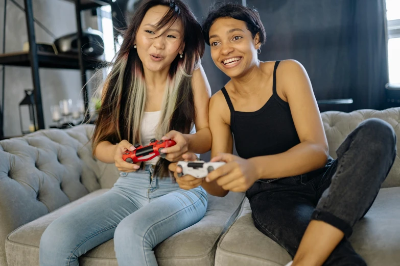 two women sitting on a couch playing video games, pexels contest winner, avatar image, asian descent, teenage boy, ad image