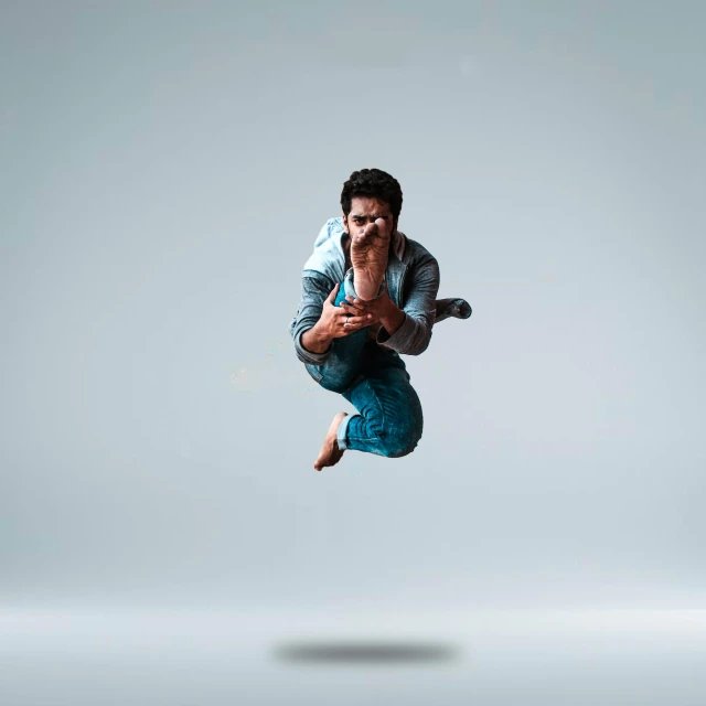 a man that is jumping in the air, an album cover, by Daryush Shokof, pexels contest winner, arabesque, dynamic pose realistic, vijay jayant props, animation character, dramatic serious pose