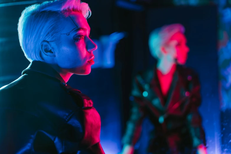 a woman standing in front of a mirror with neon lights, cyberpunk art, inspired by Elsa Bleda, trending on pexels, holography, two women, androgynous person, in a nightclub, medium shot of two characters