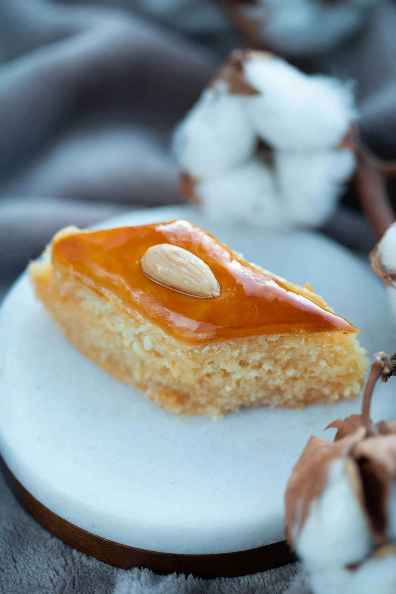 a piece of cake sitting on top of a white plate, inspired by Tang Di, hurufiyya, ocher details, square, sweets, nacre