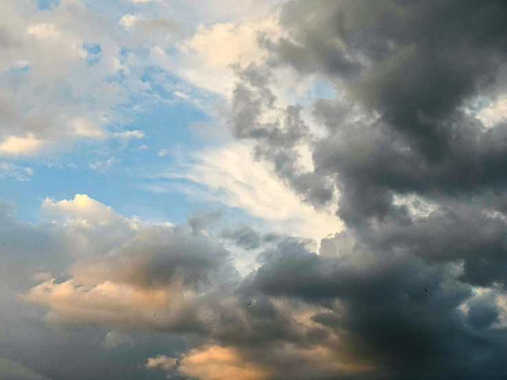 a couple of kites flying through a cloudy sky, by Carey Morris, pexels, minimalism, hyperdetailed storm clouds, archival pigment print, evening sky, layered stratocumulus clouds