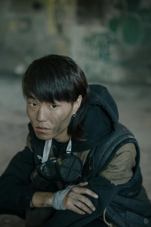 a man sitting on the ground next to a skateboard, inspired by Joong Keun Lee, metal gear movie still, headshot, [ theatrical ], korean woman