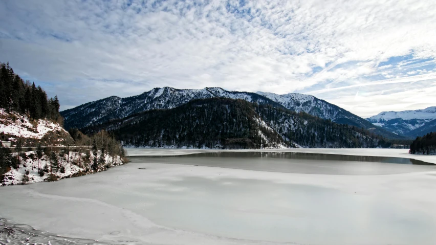 a large body of water surrounded by snow covered mountains, by Otto Meyer-Amden, pexels contest winner, frozen lake, thumbnail, white, multiple stories