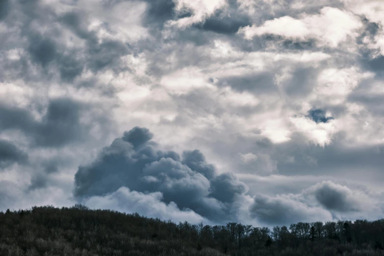 there is a large plume of smoke coming out of the sky, by Neil Blevins, pexels contest winner, overcast gray skies, sky forest background, big clouds, rolling foothills