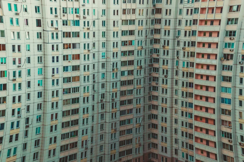 a very tall building with lots of windows, by Andrei Kolkoutine, unsplash contest winner, hyperrealism, soviet suburbs, lofi colors, drone photograpghy, aykut aydogdu