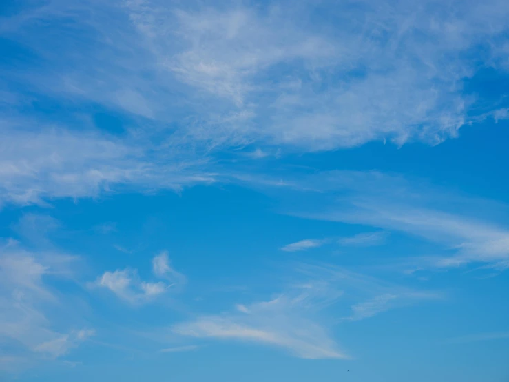 a man flying a kite on top of a lush green field, unsplash, minimalism, wispy clouds in a blue sky, cloudless-crear-sky, today\'s featured photograph 4k, alcohol with blue delirium skies