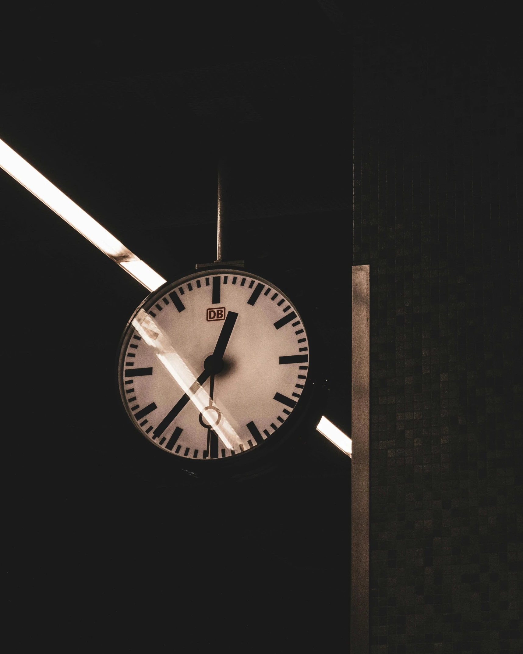 a black and white photo of a clock in the dark, unsplash, modernism, train station background, instagram post, non-binary, 2000s photo