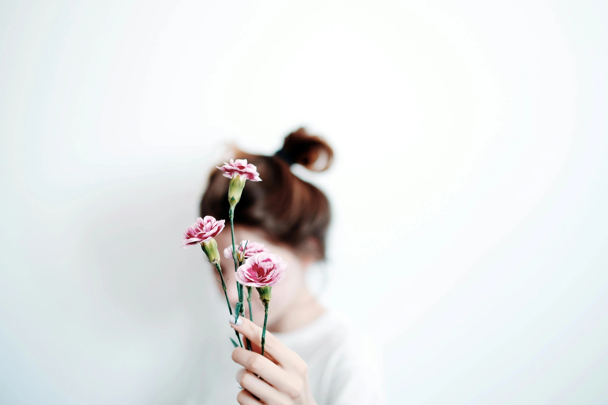 a woman holding a bunch of flowers in front of her face, a picture, pexels contest winner, minimalism, white and pink, petite girl, background image, porcelain skin ”