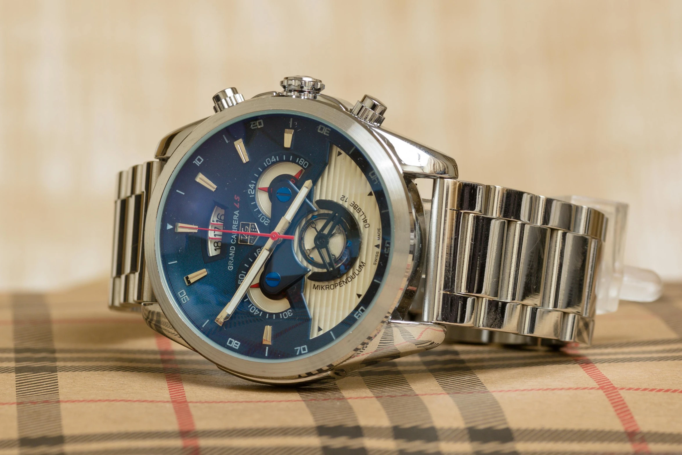 a close up of a watch on a table, by Julia Pishtar, highly polished, daytoner, profile image, fan favorite