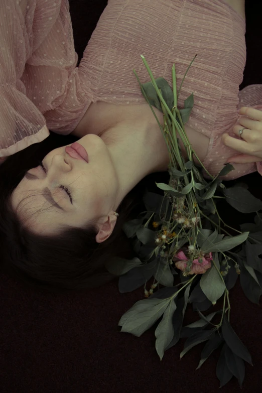 a woman laying on the ground with a bunch of flowers, unsplash, romanticism, close-up portrait film still, ignant, floating away, half image