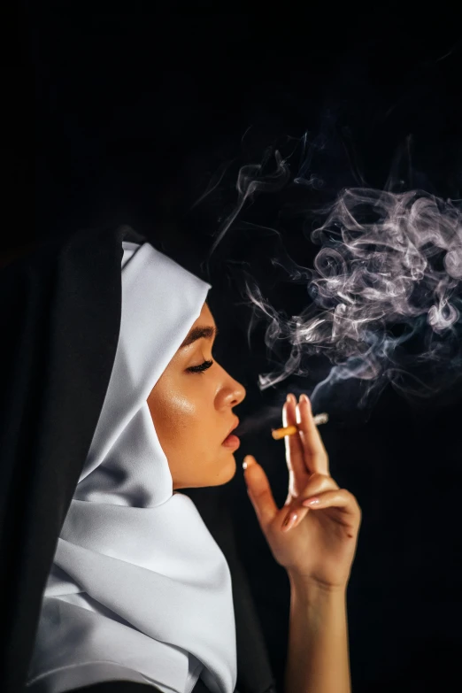 a nun smoking a cigarette in the dark, an album cover, by Hedi Xandt, pexels contest winner, white hijab, asian woman, steamy, holy rays