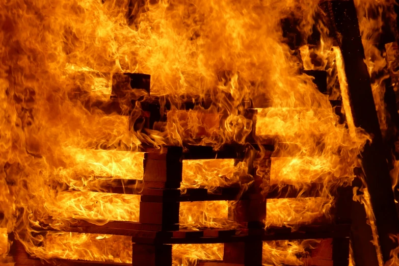 a fire burning inside of a wooden structure, by John Murdoch, pallet, closeup photo, ap news photo, 15081959 21121991 01012000 4k