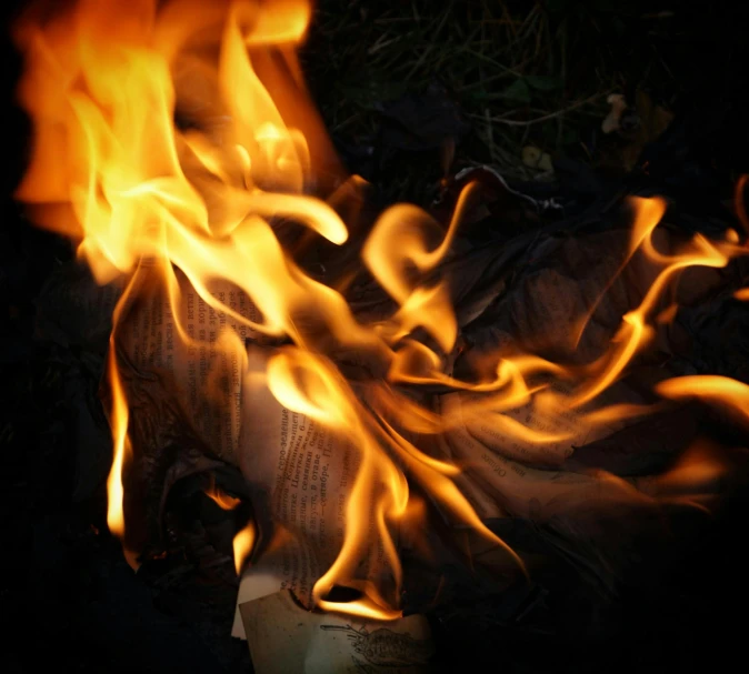 a pile of newspaper sitting on top of a fire, an album cover, by Jan Rustem, pexels contest winner, renaissance, avatar image, burning fire, close-up photo, image