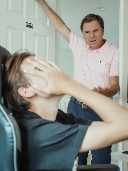 a man sitting in a chair in front of a tv, someone is screaming, caring fatherly wide forehead, profile image, mrbeast
