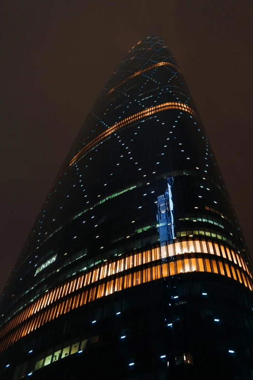 a very tall building lit up at night, bian luan, glass reflections on top, impressive detail : 7, ominous photo