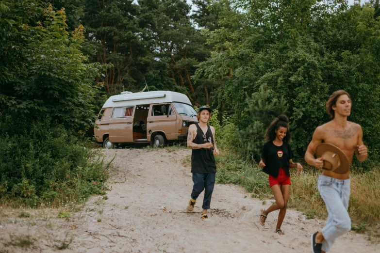 a group of people running down a dirt road, next to an rv, vsco, avatar image, swedish