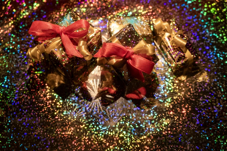 a bunch of chocolates sitting on top of a table, by Julia Pishtar, pexels, pop art, glittering multiversal ornaments, ribbon, black, thumbnail