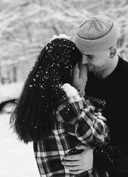 a black and white photo of a couple kissing in the snow, with black beanie on head, ✨🕌🌙, 1614572159, (beautiful) girl