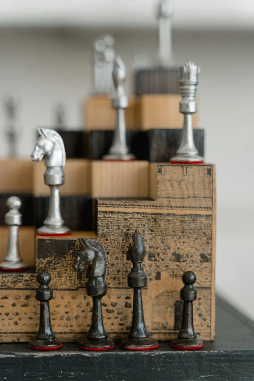 a bunch of chess pieces sitting on top of a table, kinetic art, vintage inspired, david kassan, medium close up, on wood