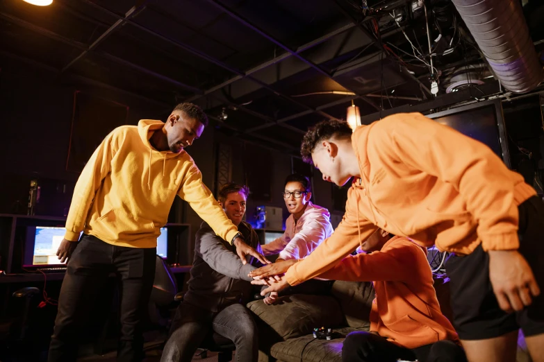 a group of young men playing a video game, pexels contest winner, interactive art, in orange clothes) fight, avatar image, uk, commercial photo