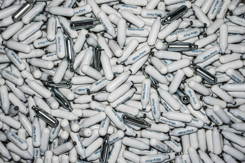 a pile of pills sitting on top of each other, a picture, bauhaus, chrome tubes, white sleeves, 10mm, sharpie