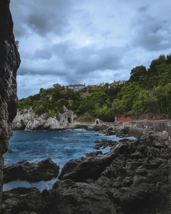 a view of the ocean from inside a cave, by Matija Jama, pexels contest winner, visual art, in the distance is a rocky hill, thumbnail, built into trees and stone, port